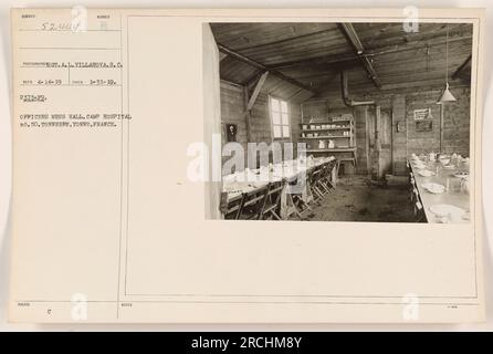 'Officers gather in the mess hall of Camp Hospital No. 50 in Tonnerre, Yonne, France. The photograph, taken on January 31, 1919, captures the daily routine of the officers stationed at the camp. The image highlights the facilities and features of the mess hall, a central meeting place for the military personnel.' Stock Photo