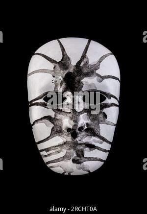 Scary white head painted black isolated on black background Stock Photo