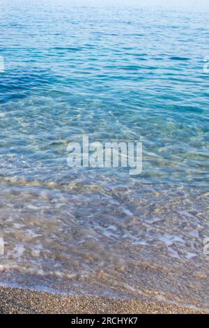 Beautiful Sandy Beach and Soft Blue Ocean Wave. Rest on the Beach in an Ecologically Clean Place. Stock Photo