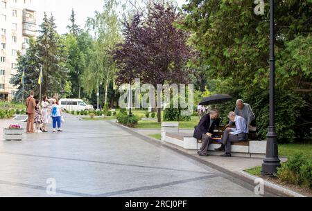 Zhytomyr, Ukraine, June 28, 2023: Three Elderly Men are Playing Chess. Senior Man Planning his Next Chess Move. Playing Chess in the Park. Stock Photo