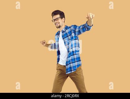 Portrait of happy excited young man dancing celebrating success Stock Photo
