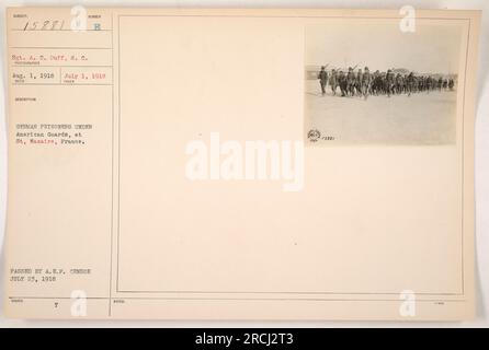 German prisoners of war being guarded by American soldiers in Saint-Nazaire, Loire-Inférieure, France. Photograph taken by Sgt. A. C. Duff on August 1, 1918. The image shows the German prisoners under American custody at St. Nazaire. This photograph was issued and passed by the A.E.F. censor on July 23, 1918. Notes indicate the photograph is labeled as 15881. Stock Photo