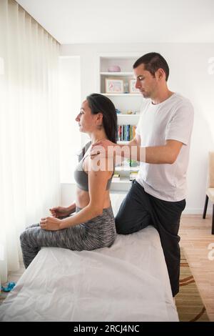 Therapist doing a session with various exercises to improve the patient's postural condition. Exercises to relieve back pain. Action Stock Photo