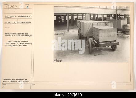 Sgt. James L. McGarrigle is shown crating motor trucks for overseas use at Camp Holabird, MD. The front view features a Liberty Truck, model B, with a crating covering the motor and seat. This photograph was censored and released by the M.I.D. Censor on September 27, 1918, and is labeled as 79267 for documentation purposes. Stock Photo