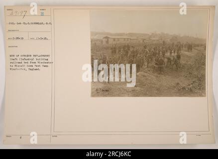 Soldiers of the October Replacement Draft (Infantry) building a railroad bed from Winchester to Winnall Down Pest Camp in Winchester, England. The photo was taken on November 5, 1918, and features Sergeant 1st Class C. Donnelly, S.C., who was the photographer. This is image number 39197 from the collection. Stock Photo