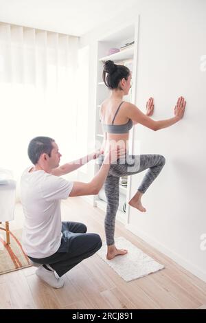 Therapist doing a session with various exercises to improve the patient's postural condition. Exercises to relieve back pain. Action Stock Photo