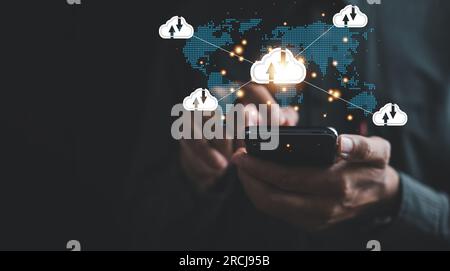 A businessman's smartphone engages with a digital dashboard, symbolizing integration of cloud technology Stock Photo