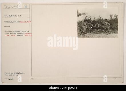 Soldiers carrying one of their wounded comrades in Bourouilles, Meuse, France during World War I. This photograph, taken on September 26, 1918, shows the dedication and bravery of the soldiers in helping their injured comrade. The image was received by the photographer on November 4, 1918, and passed by the A.E.F. Censor. Stock Photo