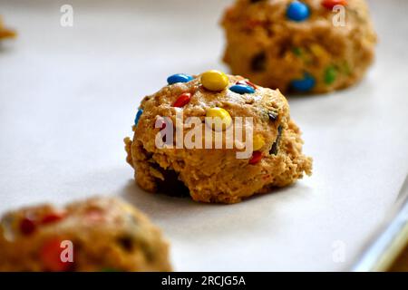 Monster cookie dough on a parchment paper lined baking sheet Stock Photo