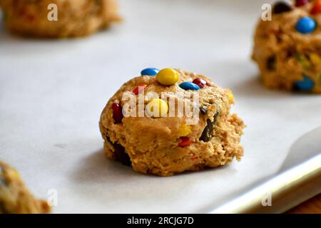 Monster cookie dough on a parchment paper lined baking sheet Stock Photo