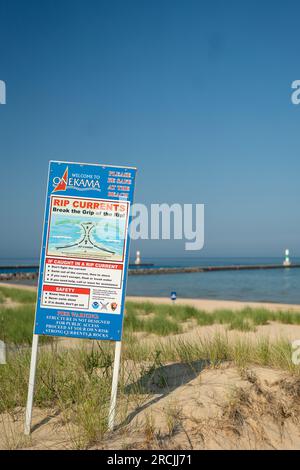 Rip current warning sign at the beach along Lake Michigan Stock Photo
