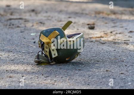 U.S. World War II tanker helmet lies on the ground Stock Photo