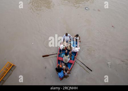 New Delhi, India. 14th July, 2023. People row their boat on a flooded road after a rise in the water level of the river Yamuna following heavy monsoon rains in New Delhi. The government issued warnings of flood-like conditions and asked people living in the riverbed or low-lying areas to evacuate their homes. Credit: SOPA Images Limited/Alamy Live News Stock Photo