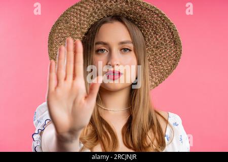 Uninterested woman disapproving with NO hand sign gesture. Denying, rejecting. Stock Photo