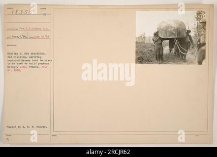 Soldiers from Company F, 6th Engineers of the 3rd Division are seen carrying a captured German boat to a river in Mezy, France, on July 24, 1918. The boat is intended to be used to construct a pontoon bridge. Photograph taken by Pvt. J. E. Gibbon and processed by A. E. F. Censor. Stock Photo