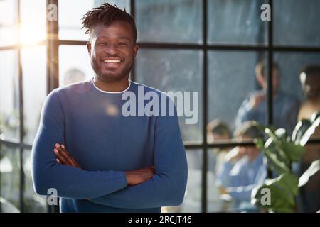 Handsome cheerful african american executive business man at the office Stock Photo
