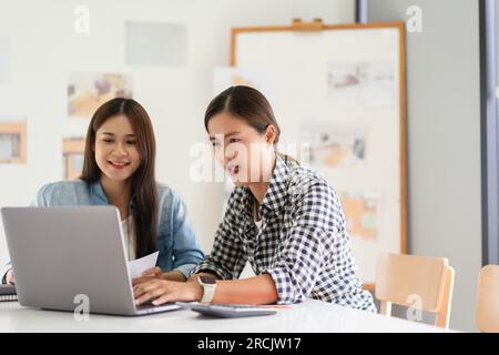 Construction design concept, Two architects is discussing about project and house plan on laptop. Stock Photo
