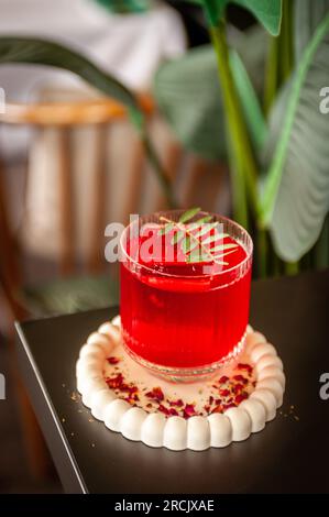 Festive pink cocktail with champagne or prosecco with ice on the table in the restaurant Stock Photo