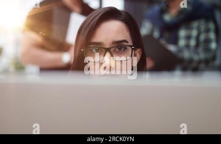 Confident businesswoman wearing casual clothes while sitting at office and working Stock Photo