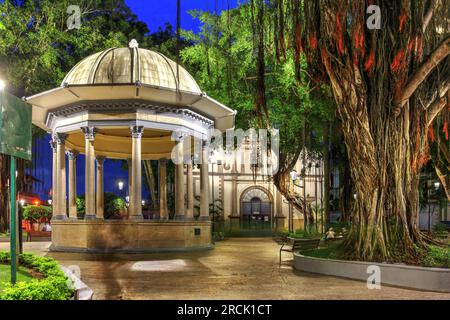 Night scene in Plaza Santa Ana, Panama Casco Viejo featuring a beautiful gazeboo and Church of Santa Ana, one of the oldest of the city. Stock Photo