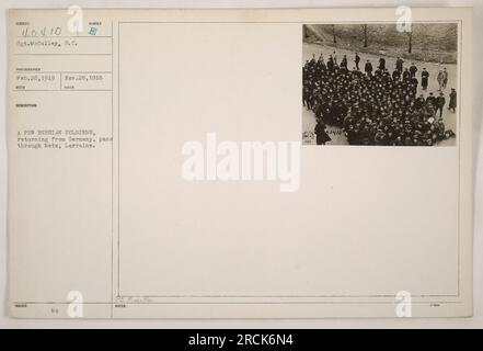 A photograph taken by Sgt. McCulley on February 26, 1919, shows a group of Russian soldiers passing through Mets, Lorraine. The soldiers are returning from Germany. This photograph has the issued number 40410 and is part of a collection titled 'Photographs of American Military Activities during World War One.' Stock Photo