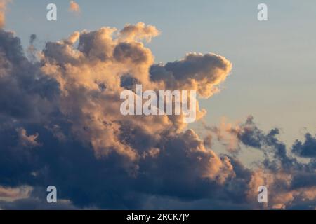 Beautiful  blue sky and cumulus clouds at sunset. Stock Photo