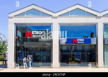 Metro bank ATM two young women using an ATM machine at the Metro bank front entrance Solihull town centre Solihull West Midlands England UK GB Europe Stock Photo