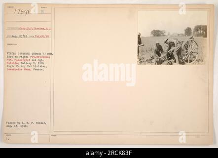 Soldiers from Battery D, 15th Regiment, Fire Artillery, 2nd Division of the American military, are seen firing a captured German 77mm gun called the SUMBER E. The photograph, taken on July 20, 1918, shows Pvt. Erickson, Pvt. Pandergiet, and Sgt. Celetta in action at Beaurpaire Farm in France. The image was received on August 27, 1918, and approved by the A.E.P. Censor on August 13, 1918. Stock Photo