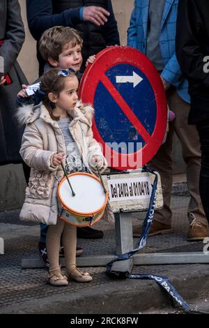 Children watching a Semana Santa procession in Zaragoza, Spain Stock Photo