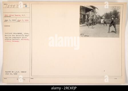 Cpl. Allan Hanson of the 121st Machine Gun Battalion is seen playing baseball in Altenach, Alsace, Germany while wearing a box respirator on June 2, 1918. This photograph was taken by an unidentified photographer and received by the subject on August 1, 1918. It was cleared by the A.E.F. censor on July 23, 1918. Stock Photo
