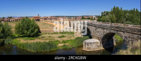 Summer's Awakening: Unveiling the Roman Bridge along the Camino de Santiago in Hospital de Orbigo, Leon, Spain Stock Photo