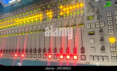 Audio mixing console with led lights in a recording studio, close up Stock Photo