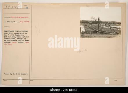 'Factual Caption: Image 78359, taken on July 24, 1918, shows a camouflaged pontoon bridge near Mesy, France. The bridge was constructed by Co. F., 6th Engineers, 3rd Division using captured German boats brought up by the Germans for the same purpose. The photograph was taken by Pvt. J. E. Gibbon, S.C.' Stock Photo