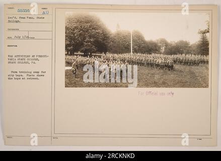 Group of city boys participating in a farm training camp at Pennsylvania State College. They are seen during a retreat session, possibly taking a break or engaging in organized activities. Photograph captured by an unknown photographer on July 1, 1918. This image is part of the collection on American military activities during World War I. Stock Photo