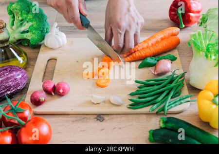Hands cutting vegetables in the kitchen Stock Photo