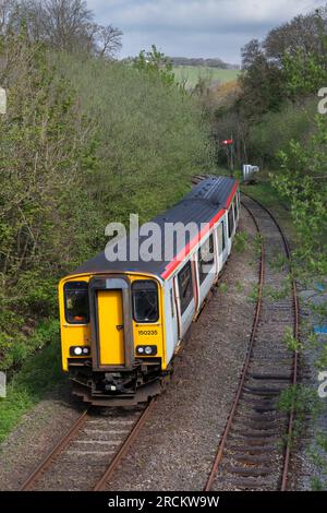 Transport For Wales class 150 diesel multiple unit train on the single track rural branch line railway passing Tondu in the Llynfil valley, Wales Stock Photo