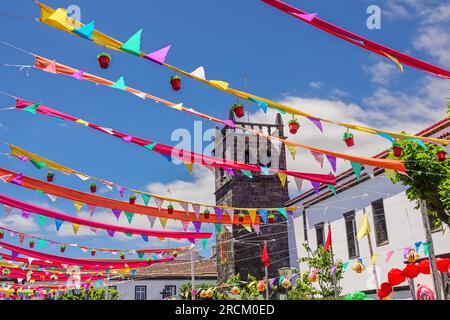Festive pennants decorate the 16th century Igreja de São Miguel Arcanjo in the historic village of Vila Franca do Campo in Sao Miguel Island, Azores, Portugal. The village was established in the middle of the 15th century by Gonçalo Vaz Botelho. Stock Photo