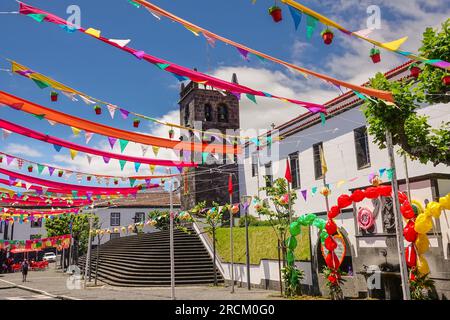 Festive pennants decorate the 16th century Igreja de São Miguel Arcanjo in the historic village of Vila Franca do Campo in Sao Miguel Island, Azores, Portugal. The village was established in the middle of the 15th century by Gonçalo Vaz Botelho. Stock Photo