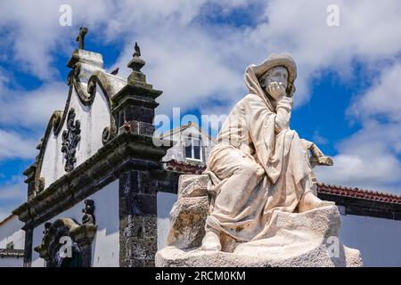 Statue of Portuguese Prince Henry the Navigator known as Infante de Sagres with the Santa Catarina Chapel behind in the historic village of Vila Franca do Campo in Sao Miguel Island, Azores, Portugal. The statue commemorates 500 years since the Portuguese discovered the Azores Islands. Stock Photo