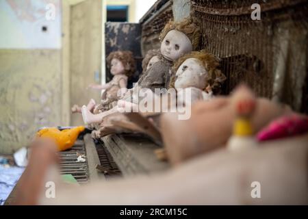 Interior decoration of abandoned private houses with piano and dolls in the exclusion zone of Belarus Stock Photo