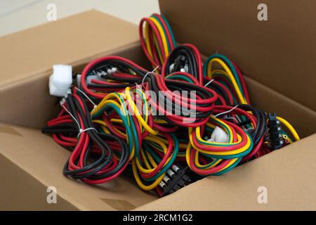 Perm, Russia - June 29, 2023: sets of multi-colored cables with connectors in a packing box Stock Photo