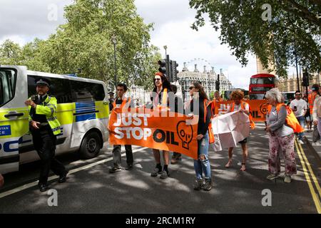 London, UK. 15th July, 2023. Members of the Just Stop Oil group with banners protest in Westminster. Just Stop Oil activists are plotting to paralyse London next week with a series of mass protests. Credit: SOPA Images Limited/Alamy Live News Stock Photo