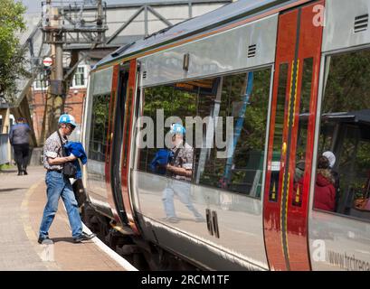 Passengers boarding a Transport For Wales train at Tondu railway station, the train is a class 170 Turbostar. Stock Photo