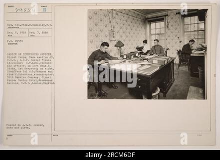 Sergeant 1st Class Chas.D. Donnelly is pictured in the Office of Disbursing Officer in London, England. Lieutenant D.T. Lebo can be seen in the center, with Charles E. Dicks, the 1st Sergeant, on the left, and chauffeur 1st Class A.L. Shannon and stenographer Miss M. Robertson on the right. This photograph was taken on either December 5, 1918 or October 7, 1918, and it was part of the RECO Division of the Signal Corps. Stock Photo