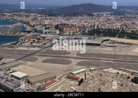 View looking north over the Gibraltar Airport runway from the Rock of Gibraltar to Spain with Winston Churchill Avenue crossing the runway Stock Photo