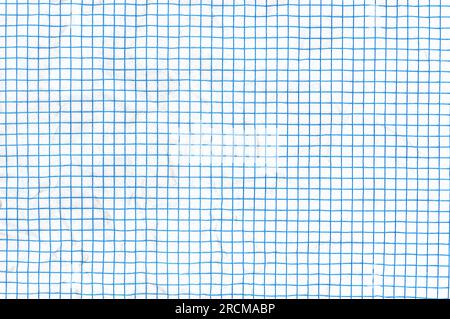Crumpled blue lined graph or grid paper. Stock Photo