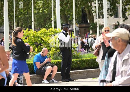 Parliament, London, UK. 15th July, 2023. Police offical filming Just Stop Oil protestors gathering in Parliament square. Credit: See Li/Picture Capital/Alamy Live News Stock Photo