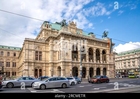 Vienna, AT – June 9, 2023 Wide three quarter view of tourists walking by the historic 1,709-seat Renaissance Revival Vienna Operahouse. The first majo Stock Photo