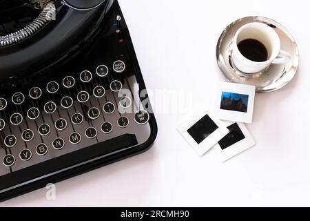 Flat lay view of mechanical typewriter with espresso and film slides Stock Photo