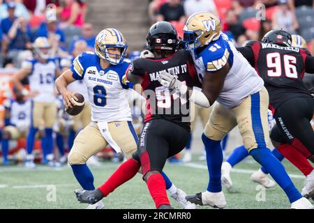 Ottawa, Canada. 15th July, 2023. Ottawa Redblacks defensive end Lorenzo Mauldin IV (94) sacks Winnipeg Blue Bombers quarterback Zach Collaros (8) in overtime during the CFL game between Winnipeg Blue Bombers and Ottawa Redblacks held at TD Place Stadium in Ottawa, Canada. Daniel Lea/CSM/Alamy Live News Stock Photo